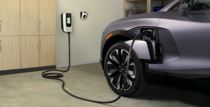 Electric car charging at a station, showcasing eco-friendly transportation and modern vehicle design.